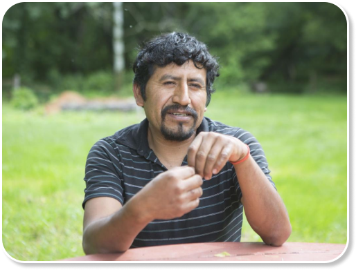 Farmer Juan sitting down and looking into camera